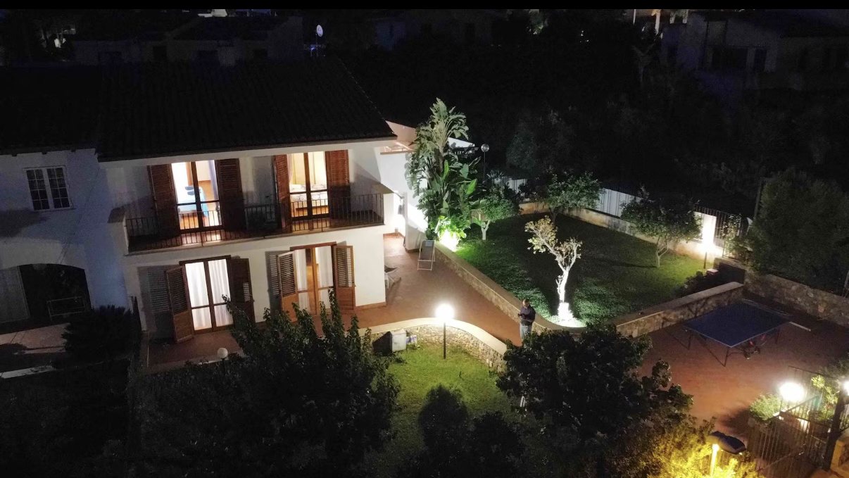 Villa Lisa illuminated at night from above